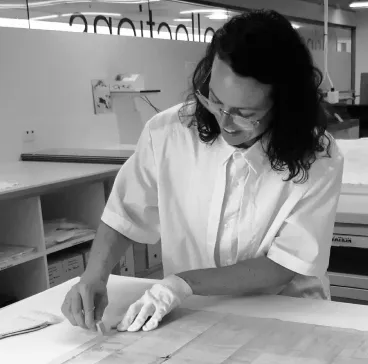 Cody Coates at work on a paper conservation treatment